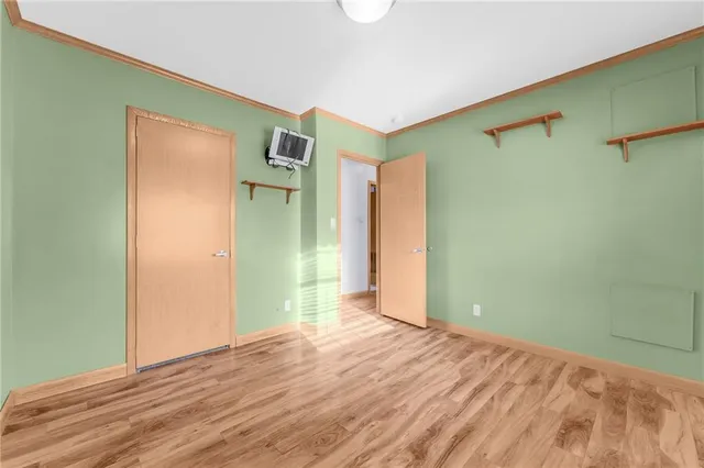 a view of a room with wooden floor and a ceiling fan