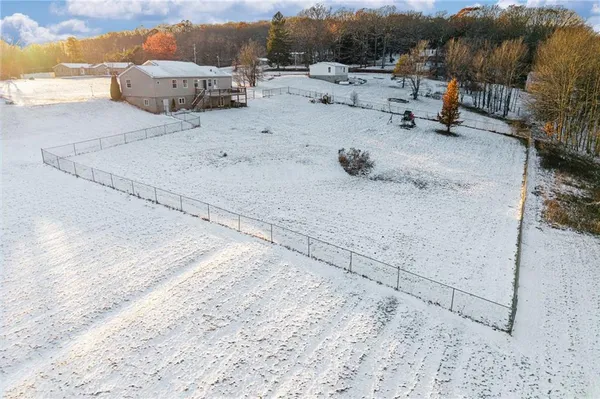a view of a house with snow on the road
