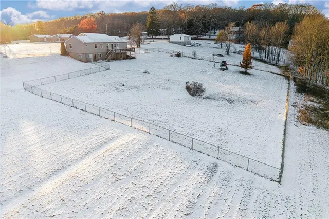 a view of a house with snow on the road
