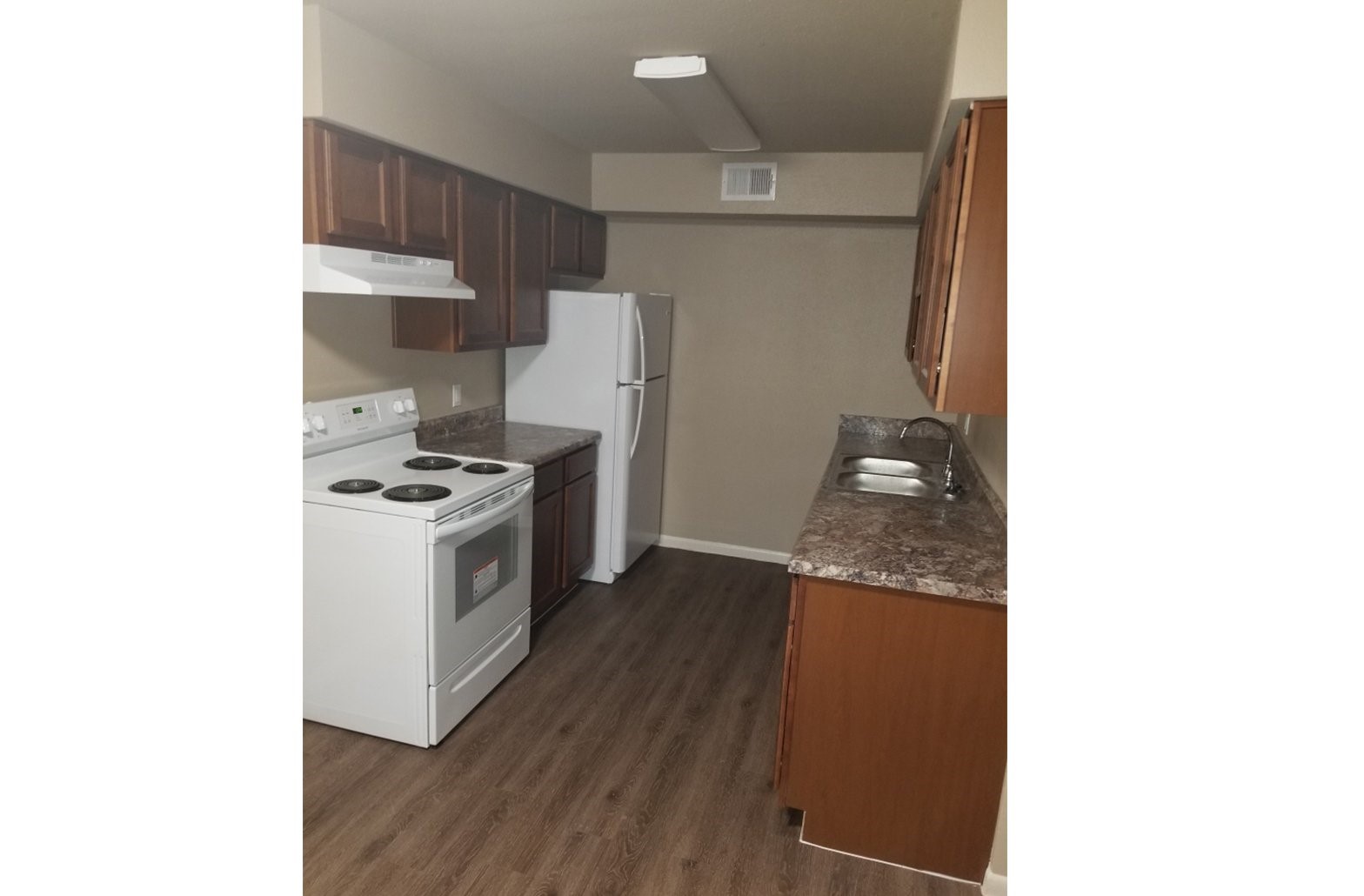 15027 Quail Ridge Road Danbury, TX 77534 - Photo 5 of 8 a kitchen with a refrigerator a stove and a microwave