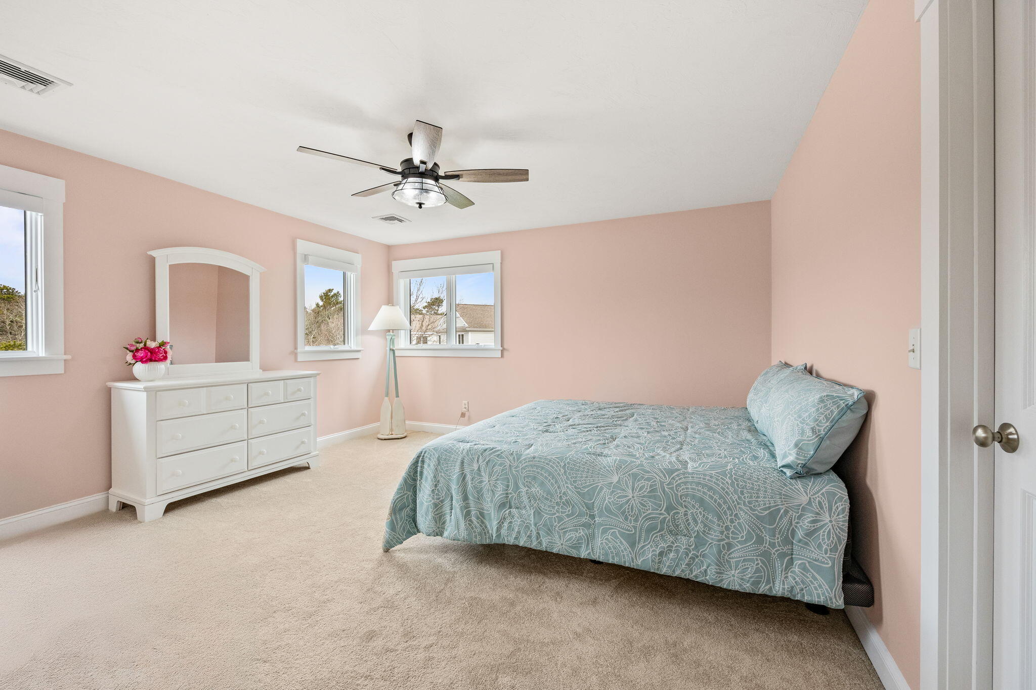 11 Aspen Road Buzzards Bay, MA 02532 - Photo 27 of 43 a bedroom with a bed chandelier dresser and a window