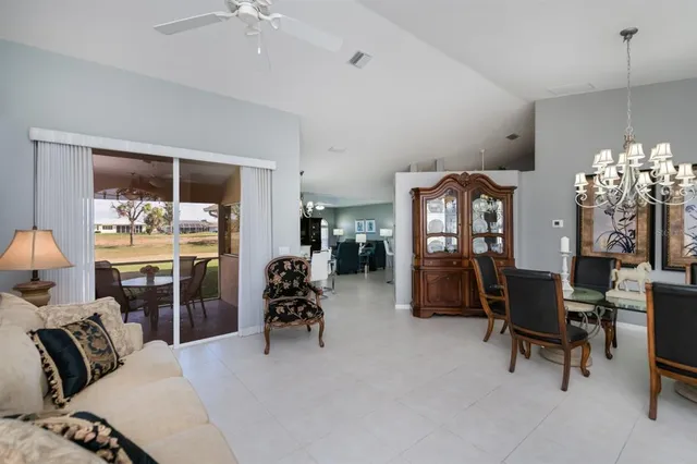 a kitchen with furniture a refrigerator and a view of living room