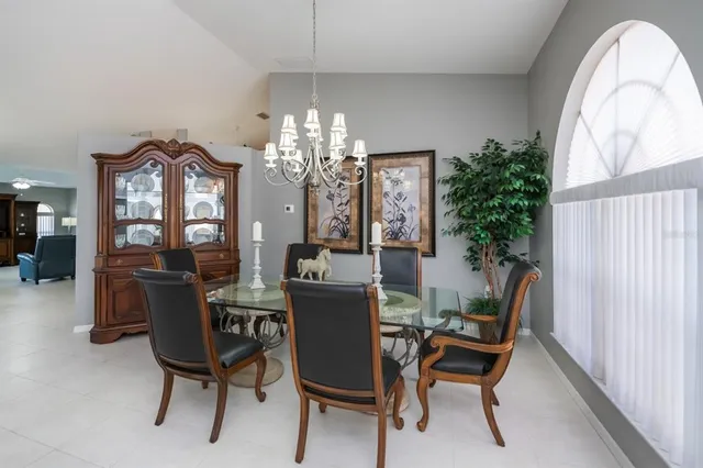 a view of a dining room with furniture and chandelier