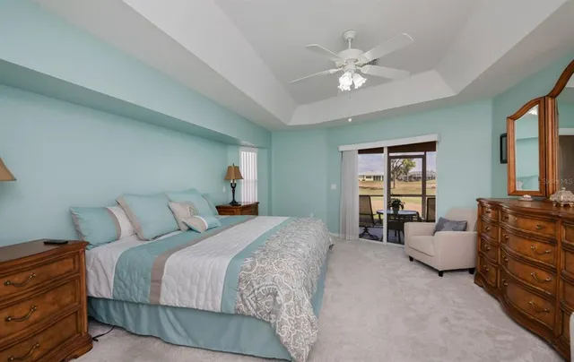 a view of a bedroom with bed and workspace