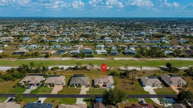 a aerial view of a house next to a big yard