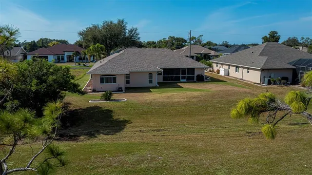 a living room with furniture a chandelier and a large window