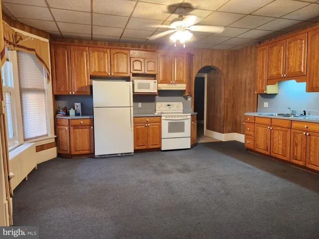 a kitchen with refrigerator and window