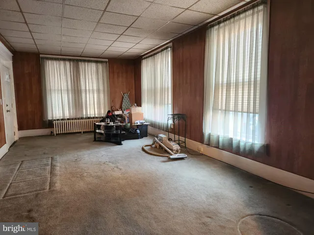 a living room with furniture and large windows