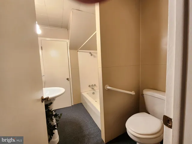 a white toilet sitting next to a bathroom sink