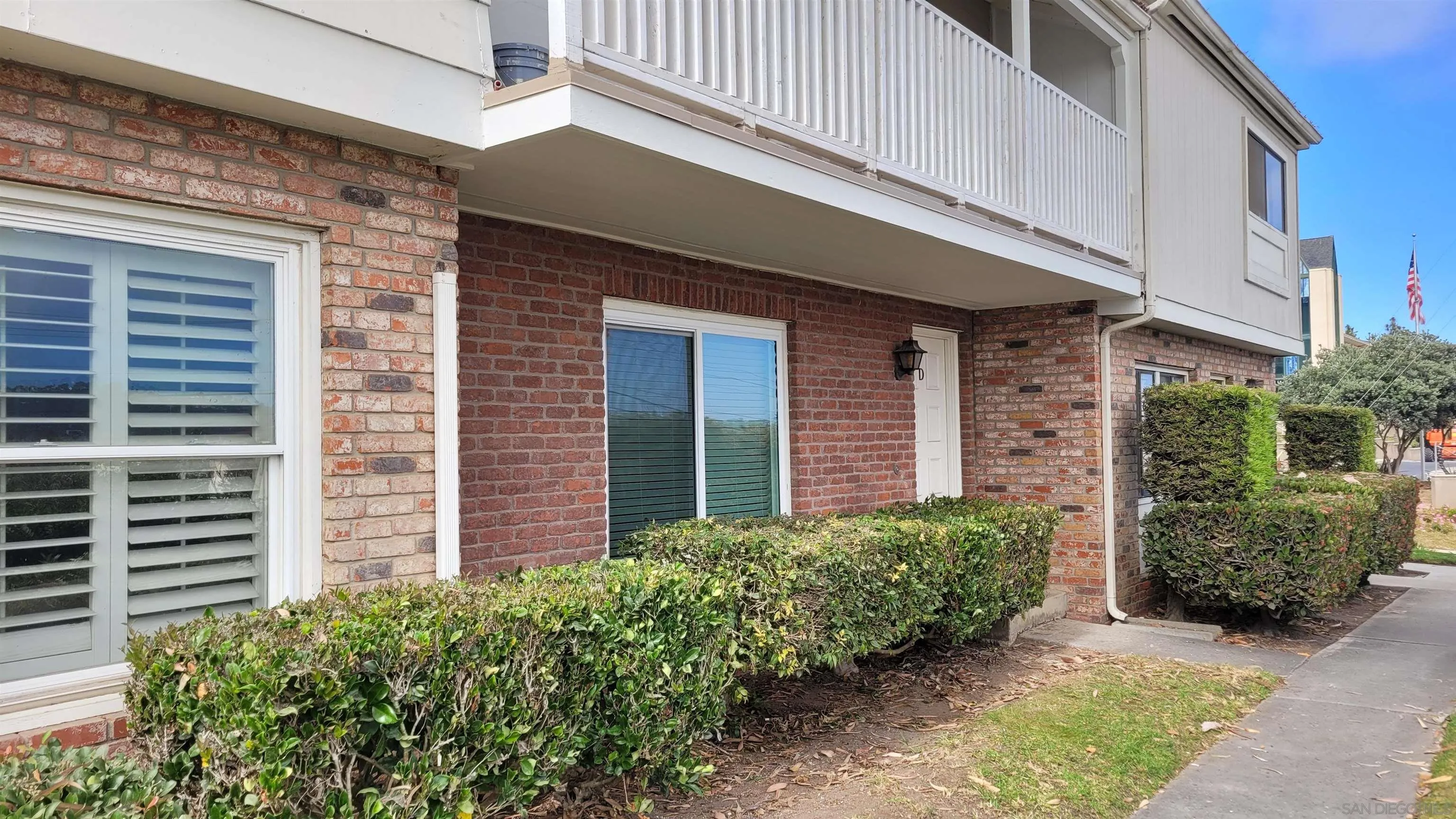 a front view of a building with plants