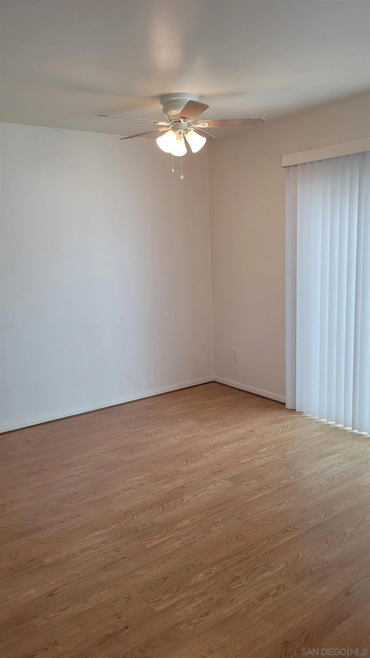 863 Del Mar Downs Road, Unit D Solana Beach, CA 92075 - Photo 9 of 23 a view of an empty room with a chandelier fan