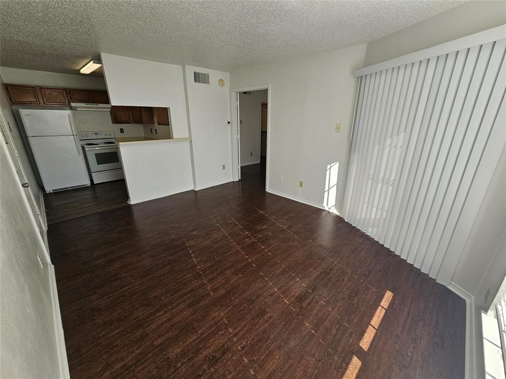 a view of a kitchen from the hallway