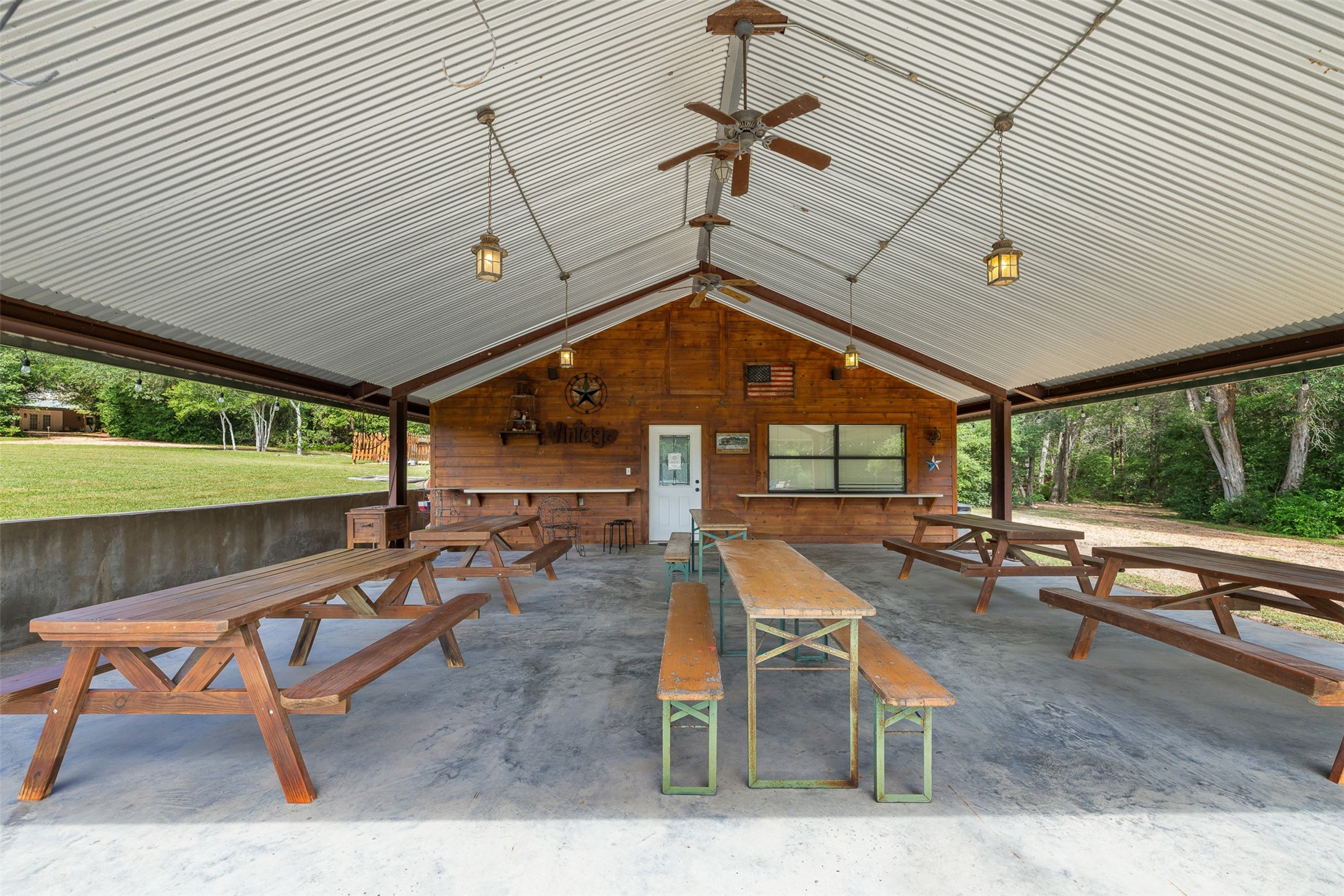 10900 Mayer Cemetery Road Burton, TX 77835 - Photo 14 of 24 a view of a patio with table and chairs potted plants with wooden floor and seating space