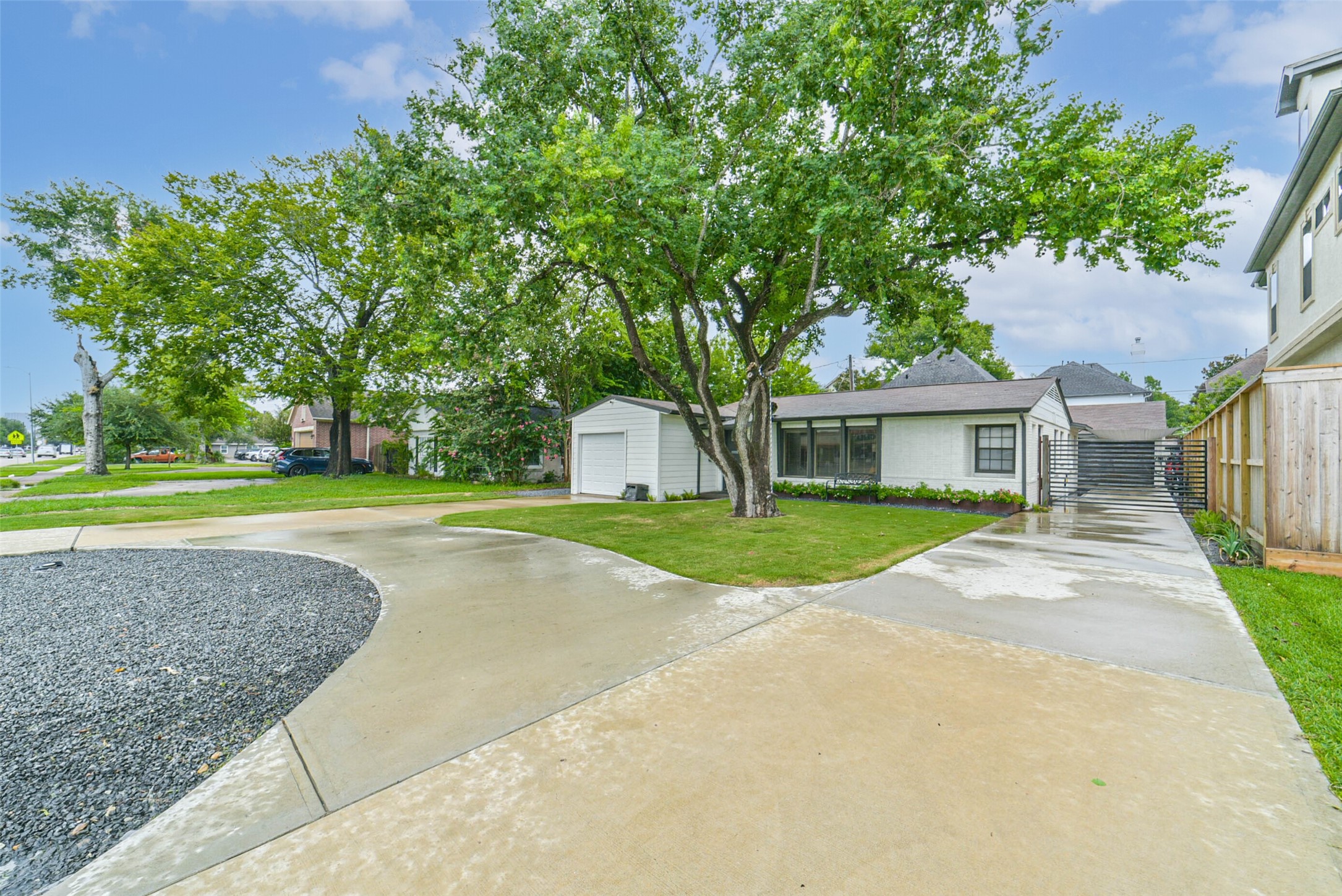 6205 South Rice Avenue Bellaire, TX 77401 - Photo 13 of 21 a view of a house with a yard and large tree