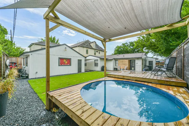 a view of house with backyard and pool