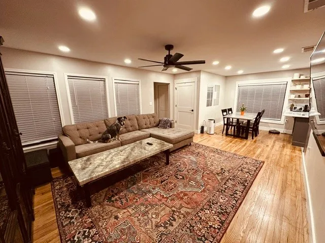 a living room with furniture rug and wooden floor