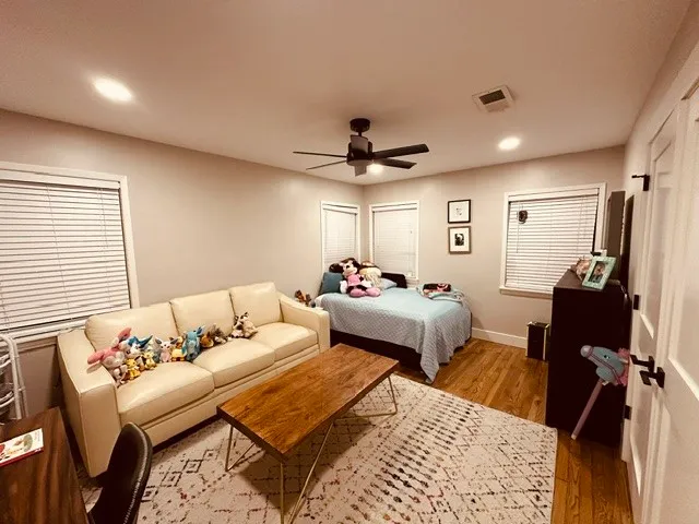 a bedroom with bed and a chandelier