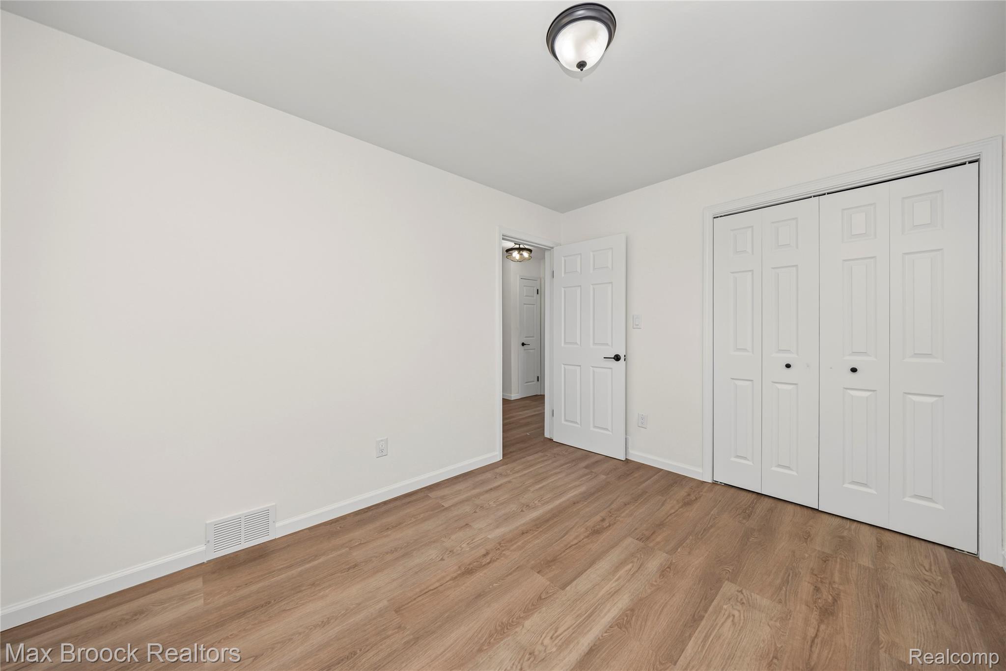 1544 Sheffield Road Birmingham, MI 48009 - Photo 17 of 51 Unfurnished bedroom with light wood finished floors and a closet