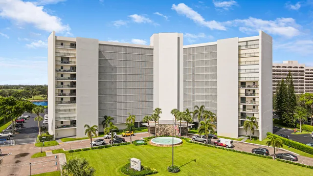 a blue swimming pool with a lawn chairs and plants