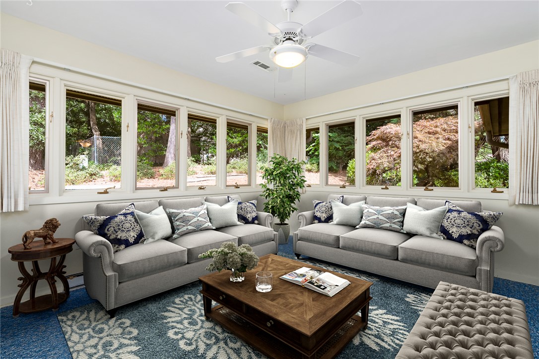 34 Hickory Way Clemson, SC 29631 - Photo 15 of 39 A naturally illuminated living room featuring large windows and a tranquil backyard view.