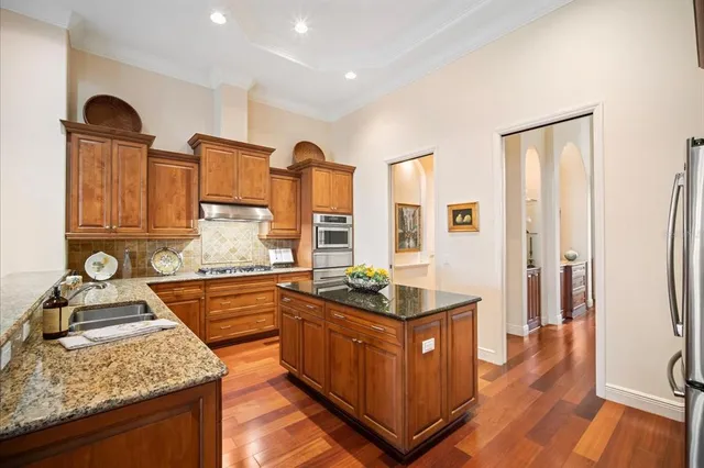 a living room with furniture a flat screen tv and a floor to ceiling window
