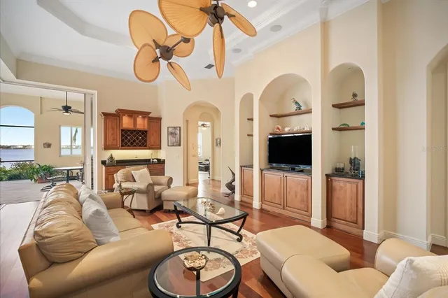 a living room with furniture a flat screen tv and a dining table