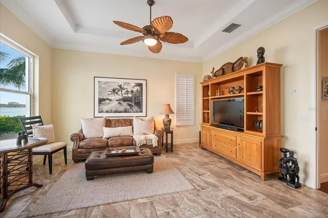 a dining room with furniture a chandelier and wooden floor
