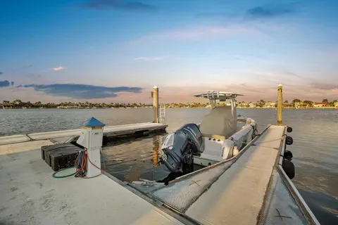 a front view of a house with a yard and potted plants