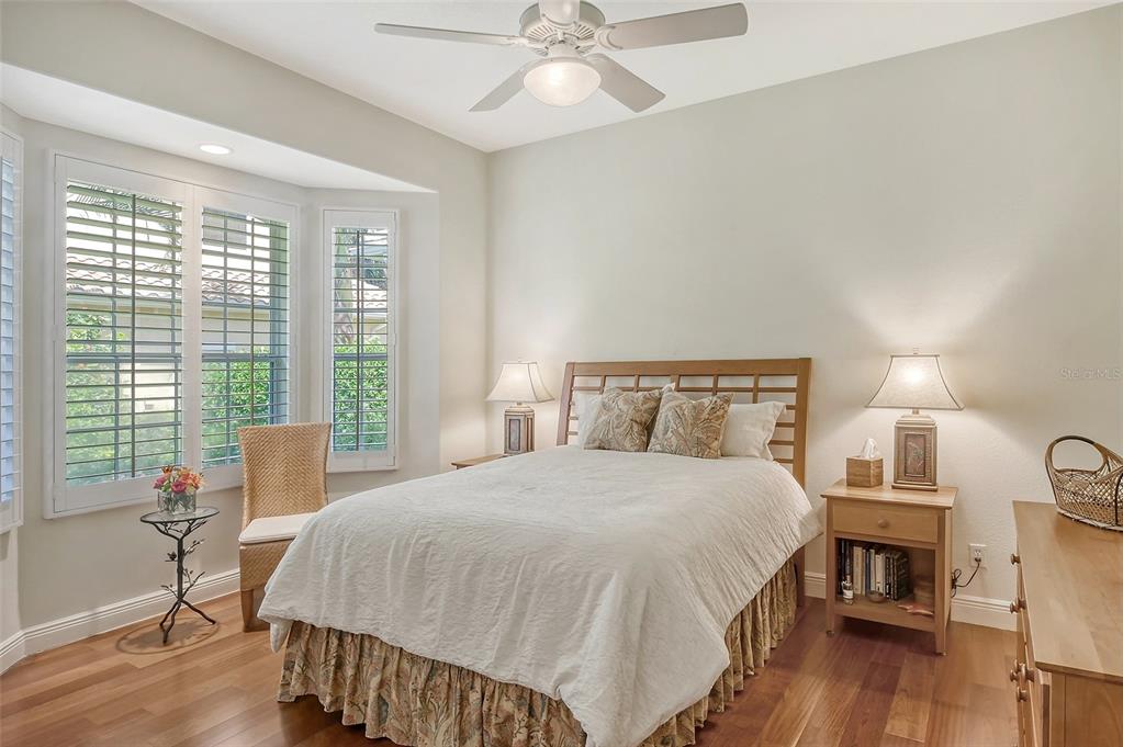 811 Riviera Dunes Way Palmetto, FL 34221 - Photo 46 of 92 a bedroom with a bed and wooden floor