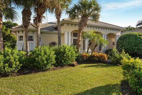 a view of a brick house with potted plants