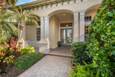 a view of a hallway with wooden floor and a living room
