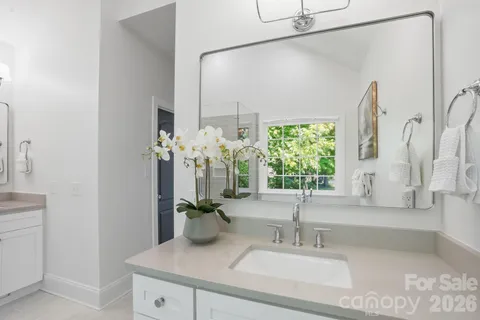 a bedroom with a bed a table and large window