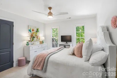 a spacious bedroom with two beds and a couch