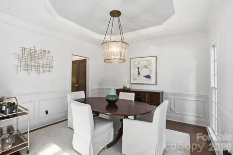 a kitchen with granite countertop white cabinets and stainless steel appliances
