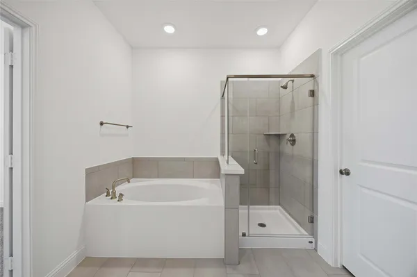 a white bath tub sitting next to a shower