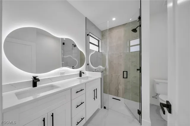 a bathroom with a double vanity sink and mirror