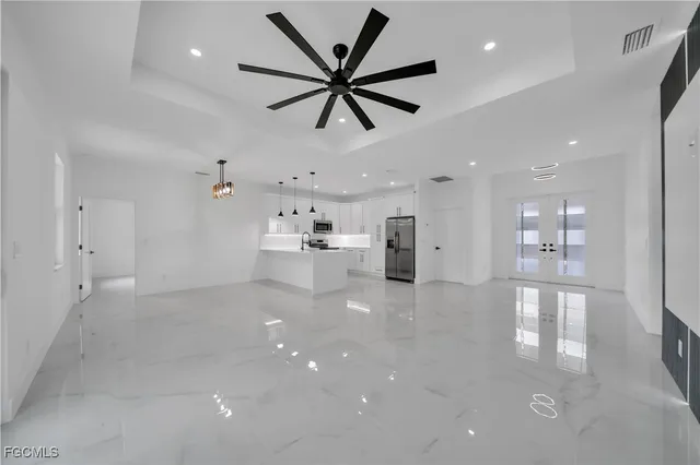 a view of empty room with wooden floor and a ceiling fan