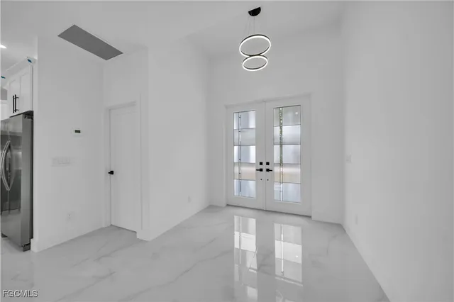 an empty room with mirror and entrance