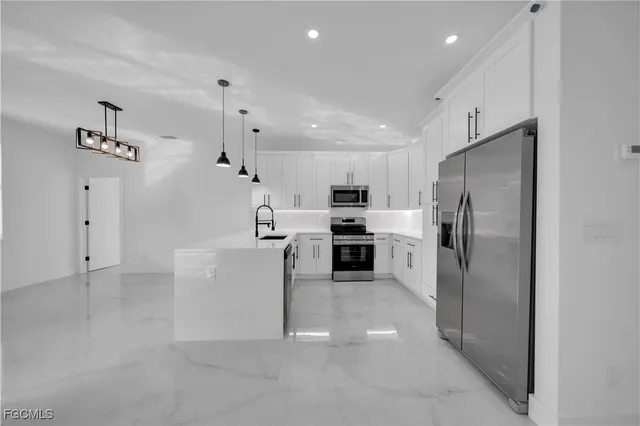 a kitchen with cabinets and stainless steel appliances