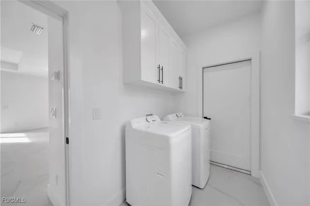 a view of storage and utility room with washer and dryer