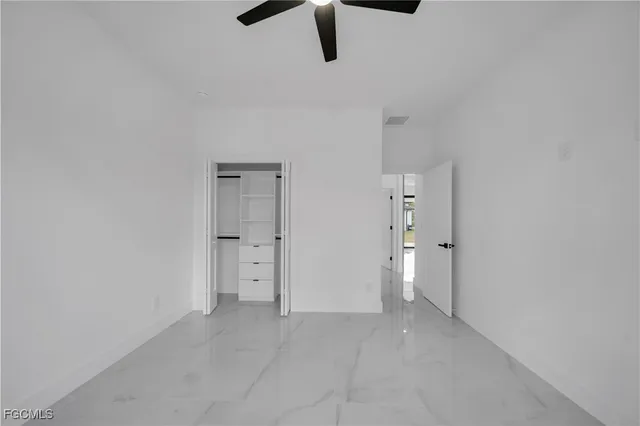 a view of a livingroom with a ceiling fan and window