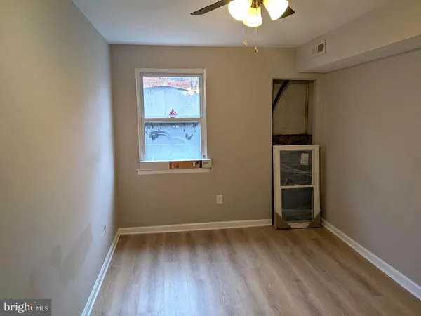 an empty room with closet and windows