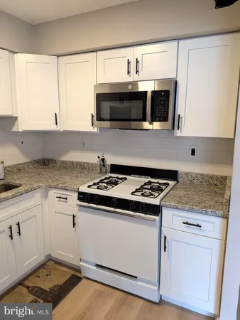 a kitchen with a stove and a microwave