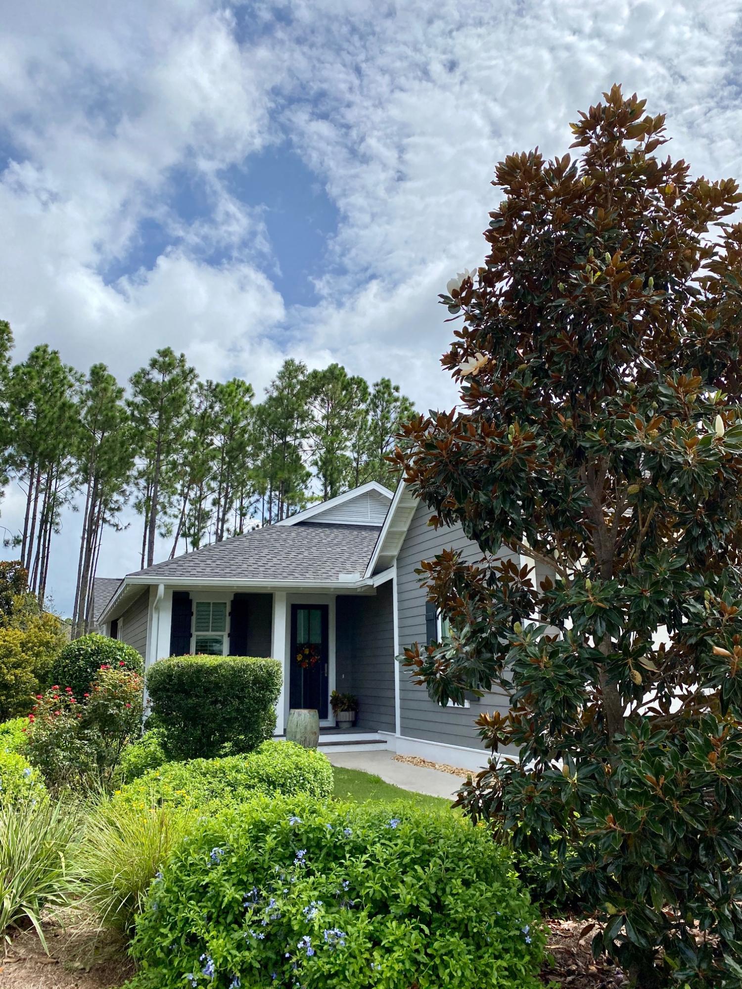 a front view of a house with a yard garage and outdoor seating