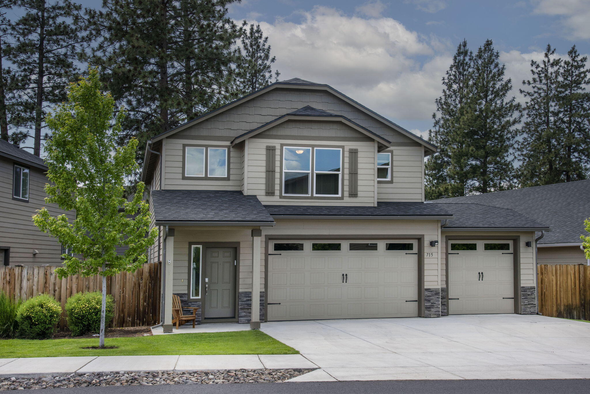 715 Brooks Camp Road Sisters, OR 97759 - Photo 1 of 25 a front view of a house with a yard and garage