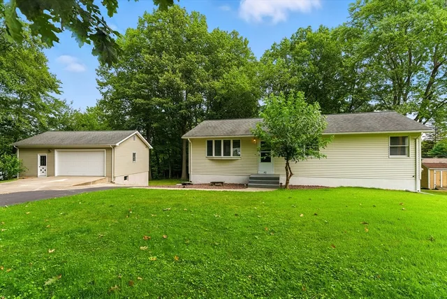 a front view of a house with a garden