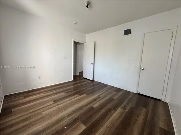 a view of room with wooden floor