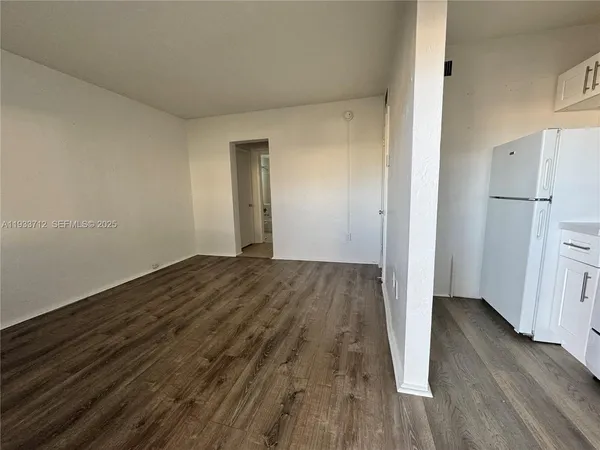 a view of a room with wooden floor