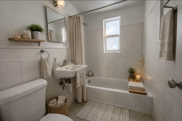 a bathroom with a sink a toilet and bathtub