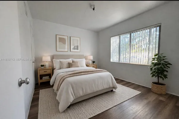 a bedroom with a bed and a potted plant